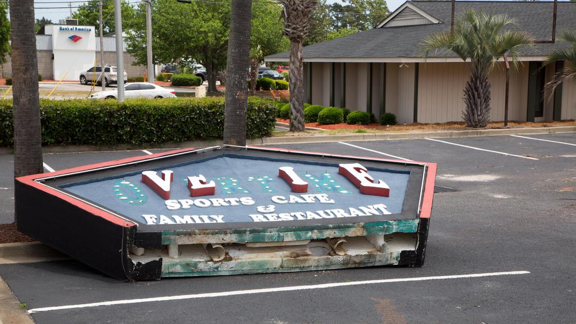 The Overtime Sports Cafe sign sits on the ground in the parking lot of the Overtime Sports Cafe in Myrtle Beach, S.C. on May 14, 2018,  after the restaurant announced they would be closing after almost 20 years. Whisky River will be taking over the location.