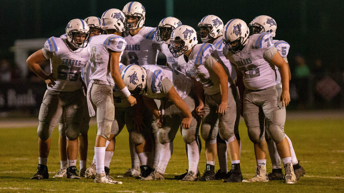 The St. James Sharks huddle during a timeout Friday night in Myrtle Beach as the Sharks take on the Carolina Forest Panthers.
