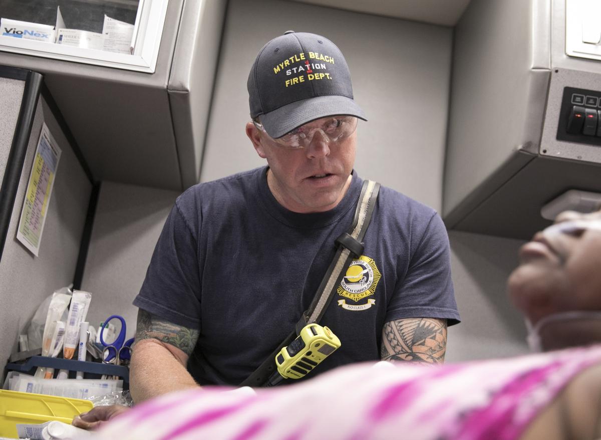Myrtle Beach Fire Rescue Engineer/Paramedic Ross Porter treats a patient in the back of his ambulance. Porter has served with the MBFR for 10 years. Aug. 7, 2018.