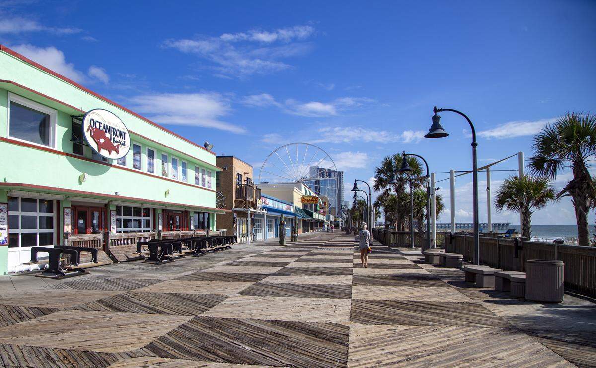 The Myrtle Beach Boardwalk sits empty in preparation for Hurrcane Florence’s arrival on Thursday. The Myrtle Beach SkyWheel can be seen in the background; all gondolas have been removed from the structure in preparation for the storm.