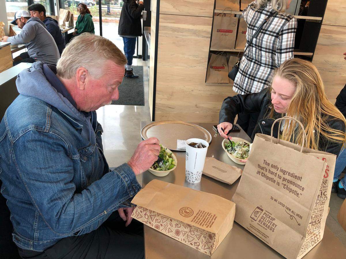 Emily Saenz brought her father Chris to the opening day of the first Chipotle Mexican Grill in the City of Conway, S.C. on Wednesday. The restaurant is located in the Tradewinds Plaza off U.S. 501 along with Food Lion and Egg’s Up Grill. December 21, 2022.