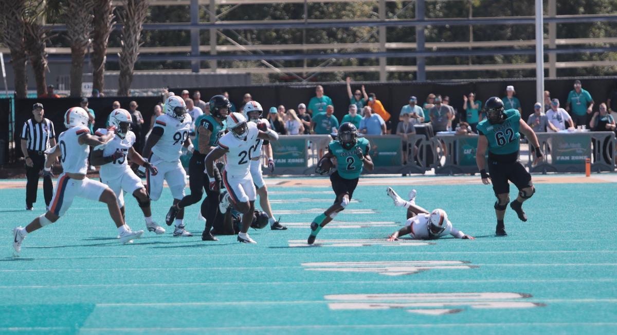 CCU wide receiver Tray Taylor evades UVA defenders in the second quarter of Coastal’s home loss to the University of Virginia Cavaliers in Conway, S.C. Brooks Stadium Saturday, Sept. 21, 2024.