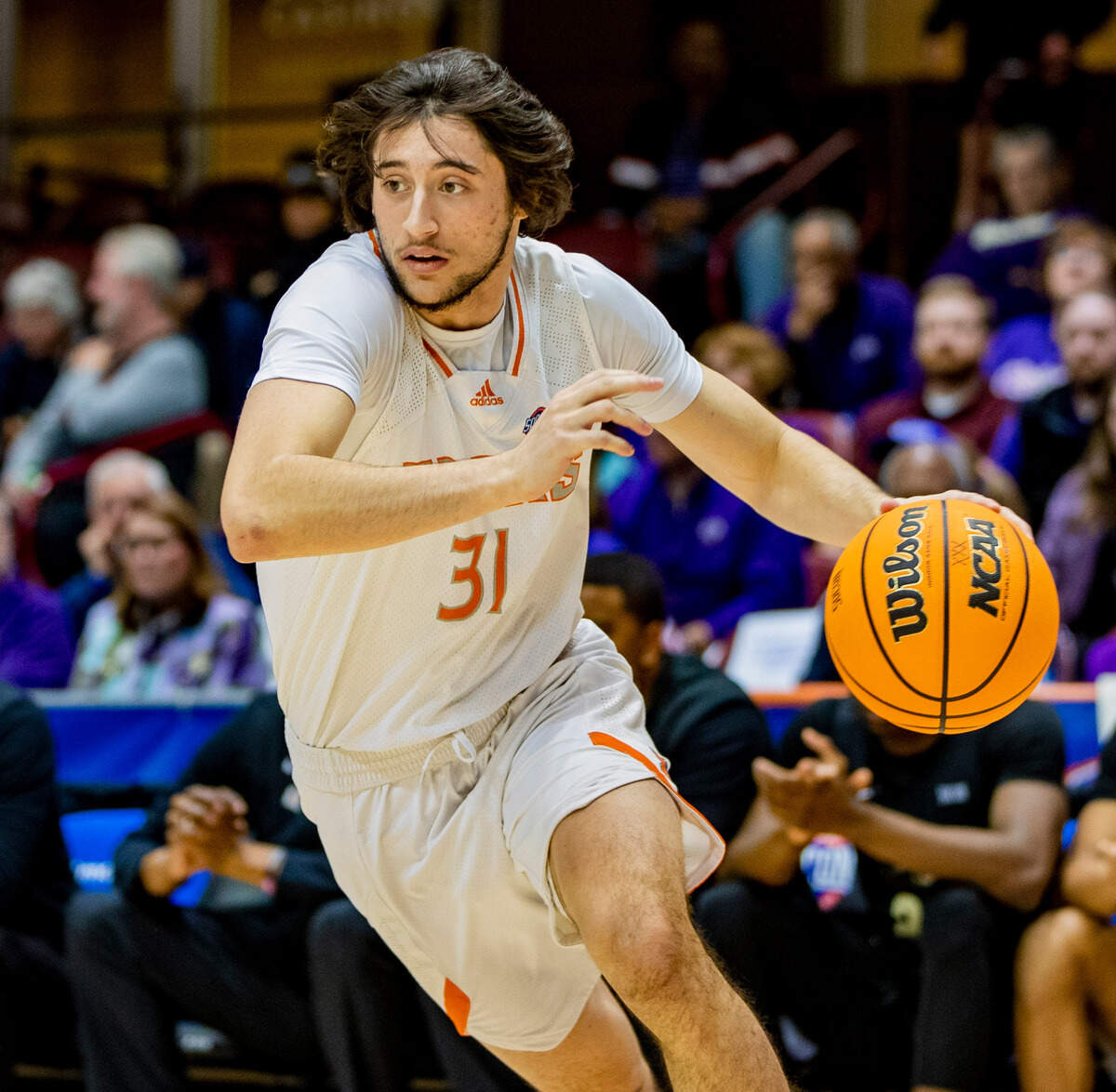 Mercer sophomore guard Jacksen Greco drives to the net against West Carolina junior forward Marlow Gilmore Friday night during the SoCOn Ingle Basketball Championships at the Harrah’s Cherokee Center in Asheville, N.C.