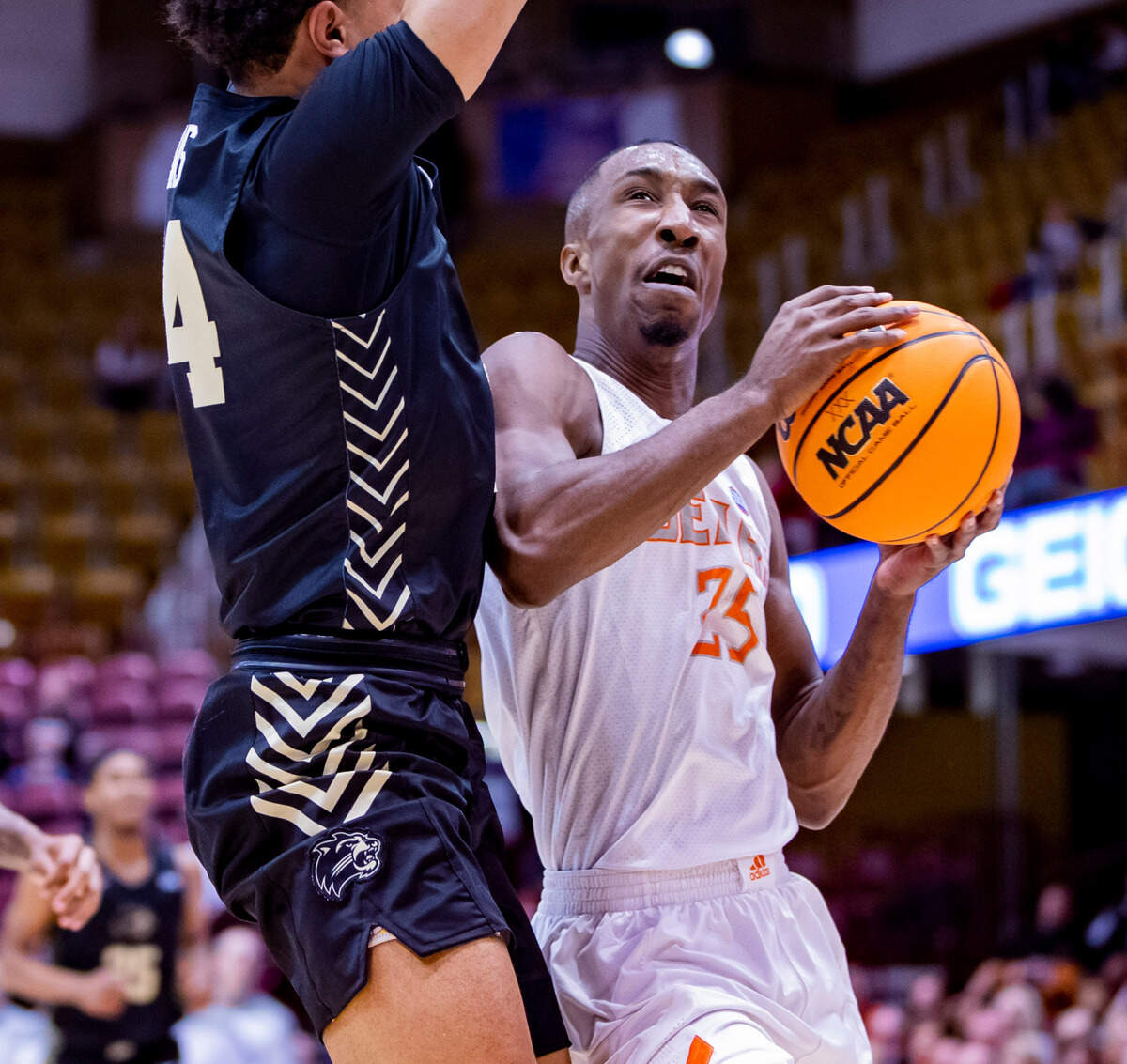 Mercer junior guard Shawn Walker Jr. drives to the net against West Carolina junior forward Marlow Gilmore Friday night during the SoCOn Ingle Basketball Championships at the Harrah’s Cherokee Center in Asheville, N.C.