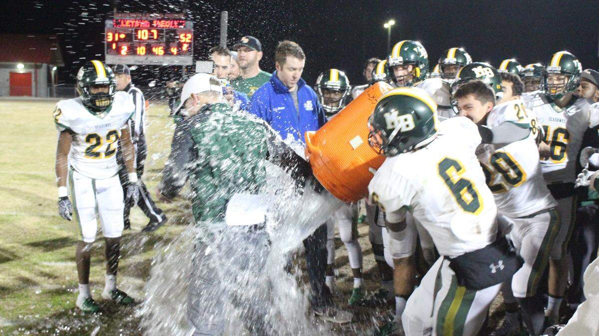 Myrtle Beach coach Mickey Wilson gets an ice water bath late in his team’s 52-31 victory over Hartsville to advance to the Class 4A state championship on Saturday.