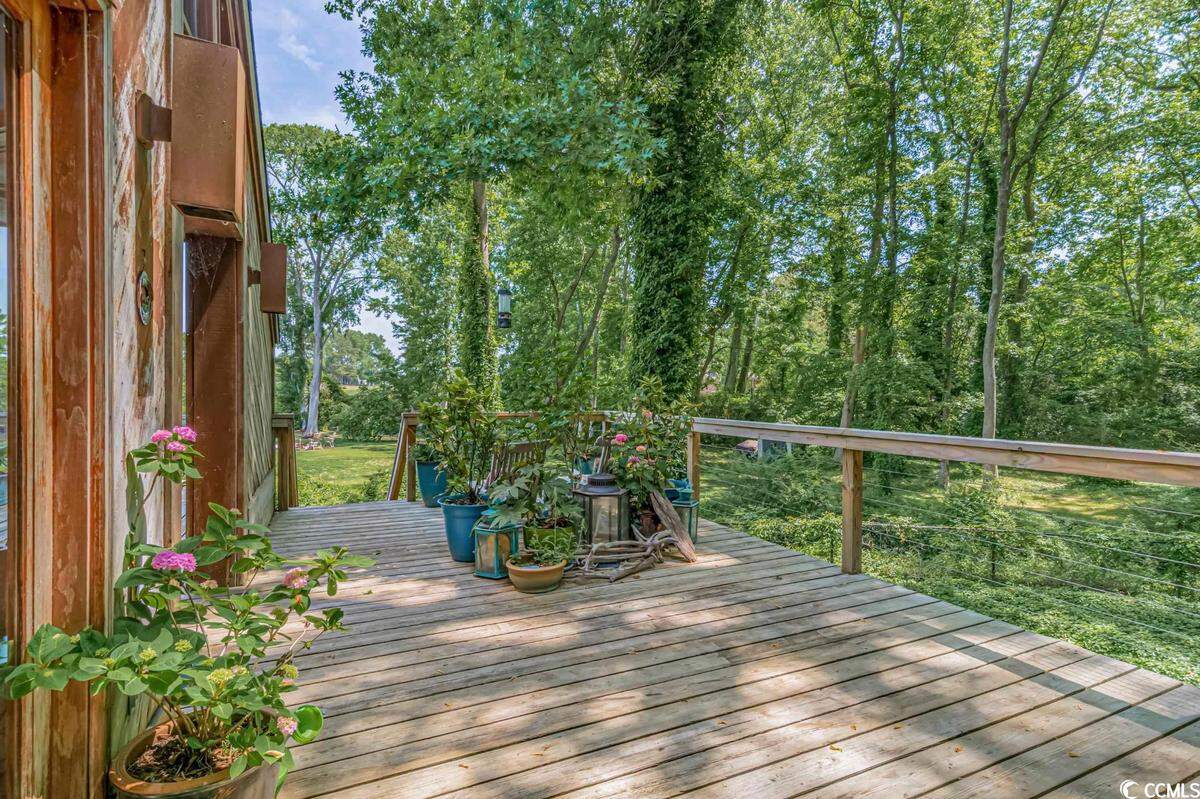 A home surrounded by trees and overlooking the Intracoastal Waterway near North Myrtle Beach is listed for $825,000. Built in 1979, the house has three bedrooms and a dock. Provided photo. Dec. 12, 2023.