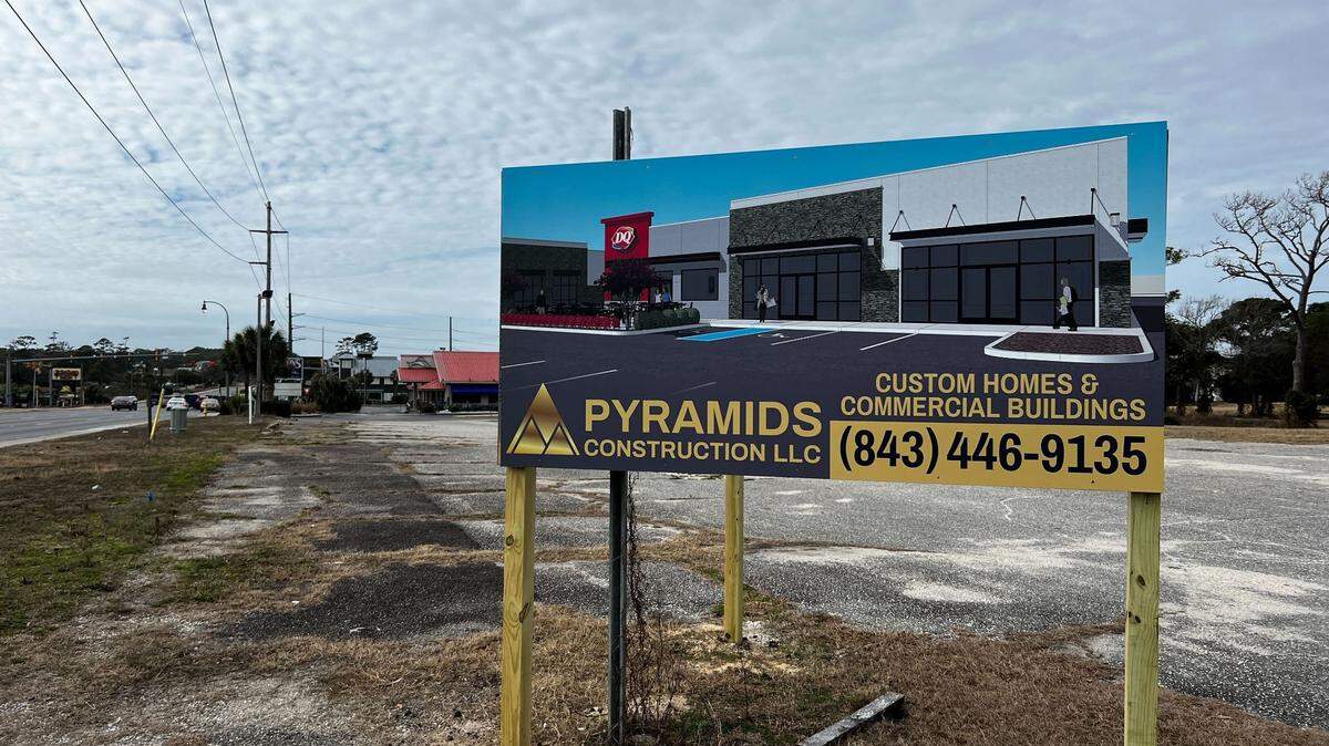A sign announcing the opening of a new Dairy Queen.
