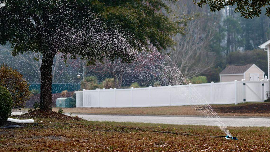 Carolina Forest residents set up sprinklers to water lawns, houses and nearby wooded areas as fire burned across more than 2,000 acres on Wednesday, March 5, 2025.