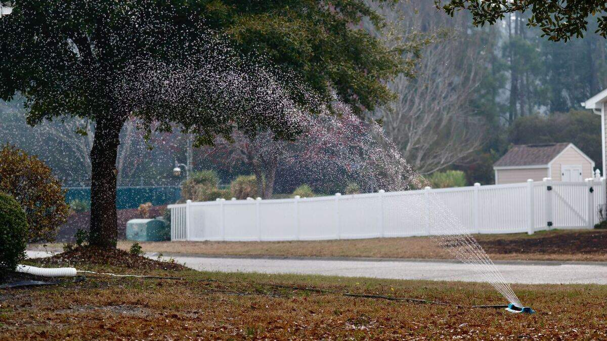 Carolina Forest residents set up sprinklers to water lawns, houses and nearby wooded areas as fire burned across more than 2,000 acres on Wednesday, March 5, 2025.