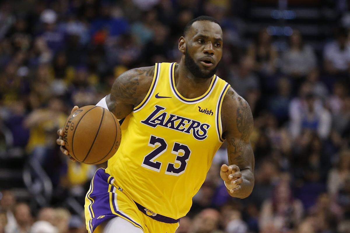 FILE - In this Saturday, March 2, 2019 file photo, Los Angeles Lakers forward LeBron James (23) controls the ball in the second half during an NBA basketball game against the Phoenix Suns in Phoenix. Though LeBron James didn’t make the playoffs in his first season in Los Angeles, his move to the Lakers paid off in jersey sales. The NBA announced Thursday, April 25, 2019 that James had the most popular individual jersey during the regular season and that the Lakers sold the most team merchandise. They knocked off Stephen Curry and the Golden State Warriors, who had been the most popular player and team for three consecutive seasons. (AP Photo/Rick Scuteri, File)