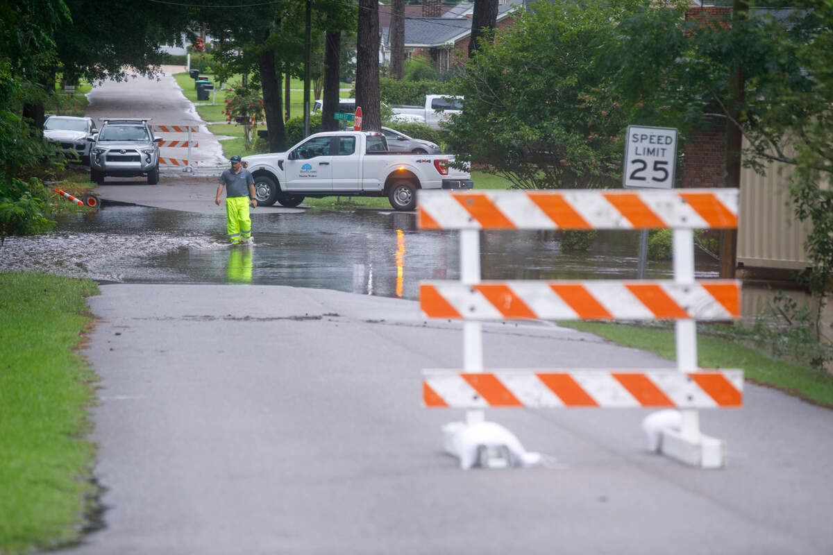 An Horry County Storm Water worker surveys the flooding on Milligan Street in Loris. Streets and homes around Loris, SC flooded due to the heavy rainfall associated with Tropical Storm Debby. Aug. 8, 2024.
