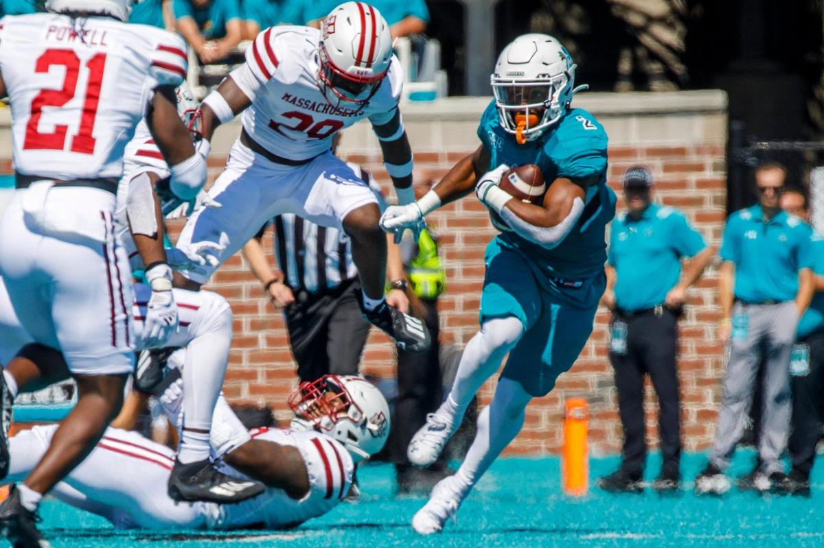 Coastal’s Reese White runs against U.Mass on Saturday. Coastal Carolina, ranked 17, defeated Massachusetts on Saturday at Brooks Stadium in Conway SC. Spectators were encouraged to wear teal for a “teal out” promotion. Aug. 11, 2021.