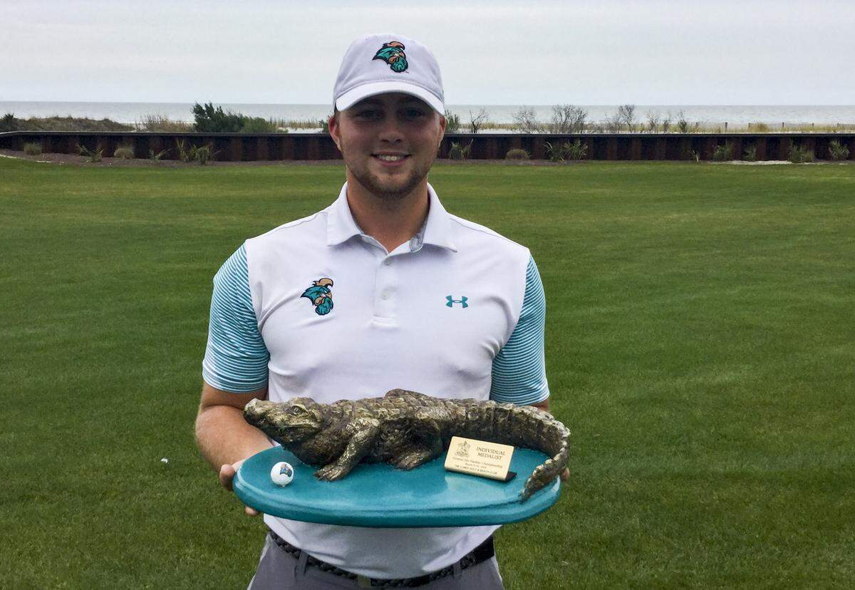 Coastal Carolina senior Zack Taylor holds the medalist’s trophy after winning the 19th General Hackler Championship at The Dunes Golf and Beach Club on March 10, 2020.