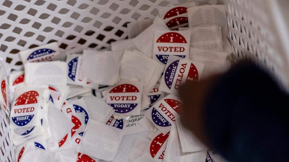 A voter takes a sticker from a basket after voting at the Mary C. Canty Recreation Center in Myrtle Beach. Voters went to polling places throughout Horry County, S.C. today to vote in local and national elections. Poll workers, wearing face shields and taking precautions, reported a strong turnout of in-person voting despite concerns over the coronavirus pandemic. November 3, 2020.
