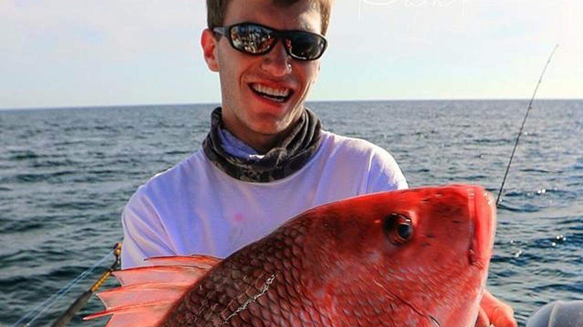Zachary Rosenberg shows off a red snapper caught aboard Painkiller out of Murrells Inlet.