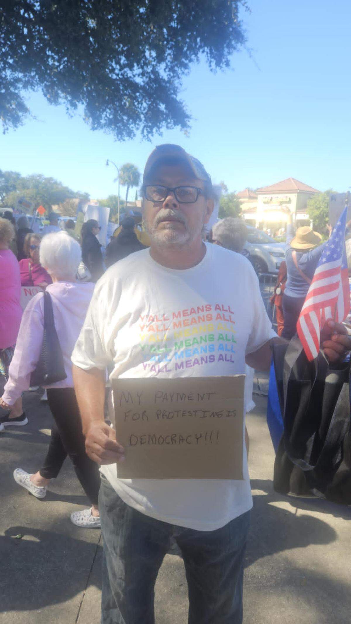 Alex Meranco, a Myrtle Beach resident, holds a sign at the “No Kings” rally in the city on Saturday, Oct. 18, 2025.