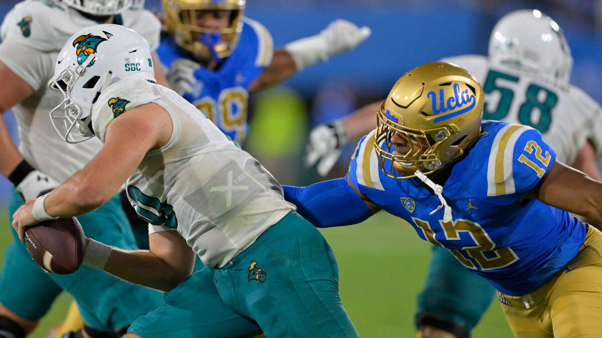UCLA Bruins defensive lineman Grayson Murphy (12) pressures Coastal Carolina Chanticleers quarterback Grayson McCall (10) in the first half at Rose Bowl.
