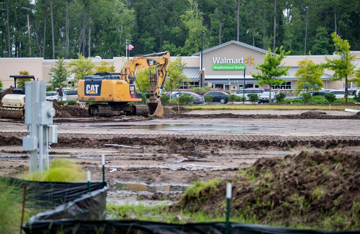 Crews work to clear a lot along Farrow Parkway in Myrtle Beach Thursday morning.