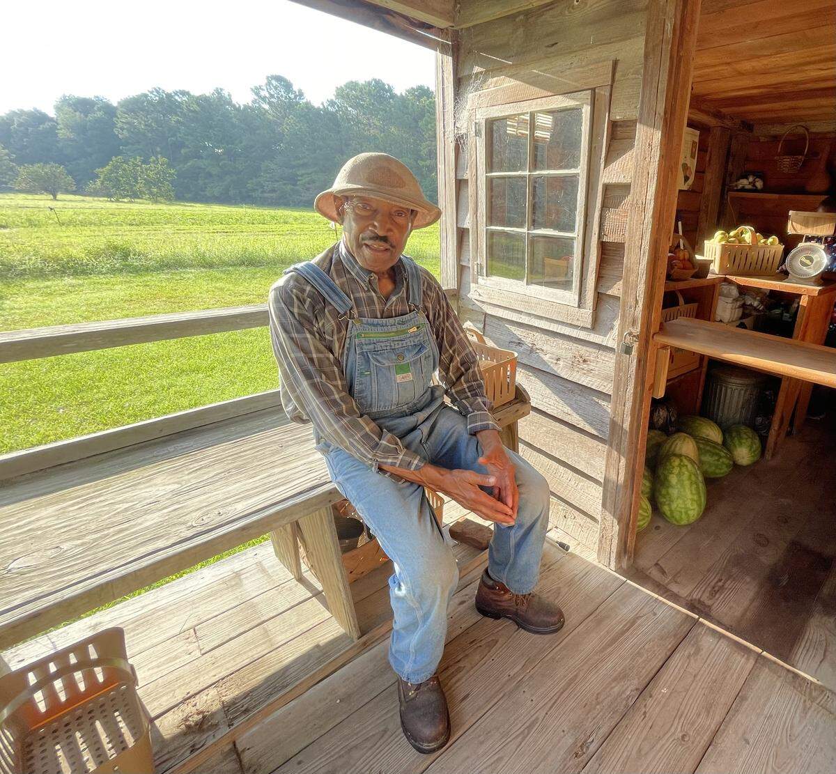 O’Neal Smalls sits near the entrance of the farmers market at Freewoods Farm in Socastee near Myrtle Beach, SC. Smalls is currently operating the farm, which is believed to the only Black living history farm in the U.S. that focuses on Black farming communities after slaves were freed following the Civil War. Aug. 17, 2025