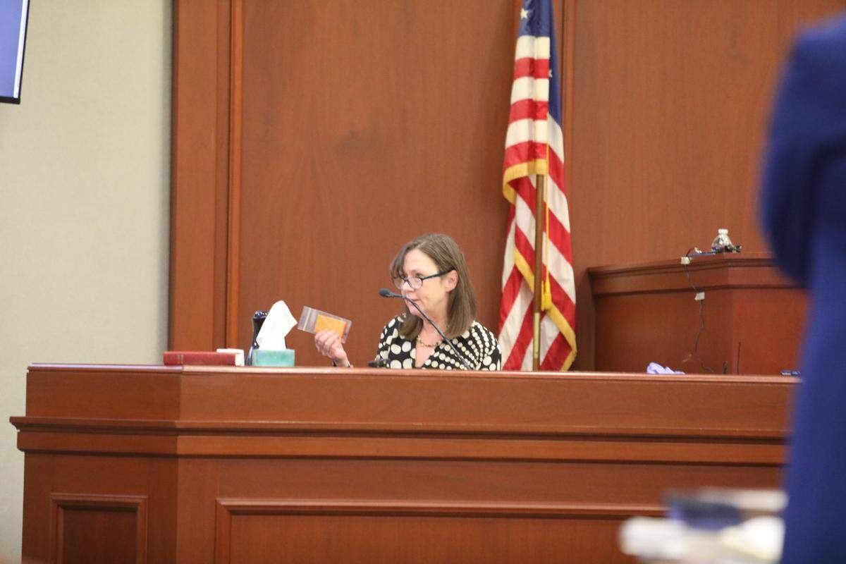 A forensic pathology doctor who performed an autopsy on Greg Rice holds up a bullet she found in his body. She said she determined he died from multiple gunshot wounds in 2020.