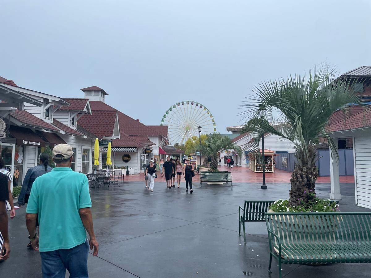 People walk around Broadway At The Beach Wednesday, Aug. 30. The shopping center is allowing vendors to decide if they stay open Thursday, Aug. 31.