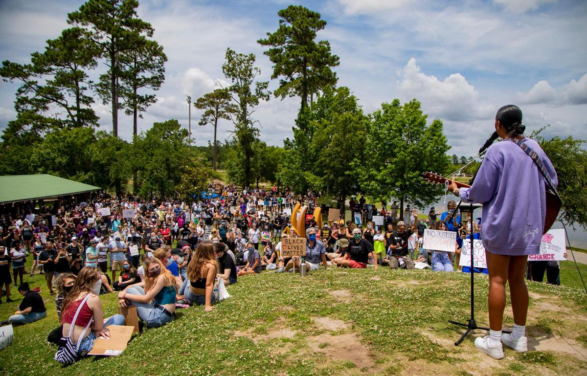 Conway High School graduate Cecily Hennigan performs for protesters atop a hill in Market Common’s Grand Park during a Black Lives Matter rally Sunday afternoon.