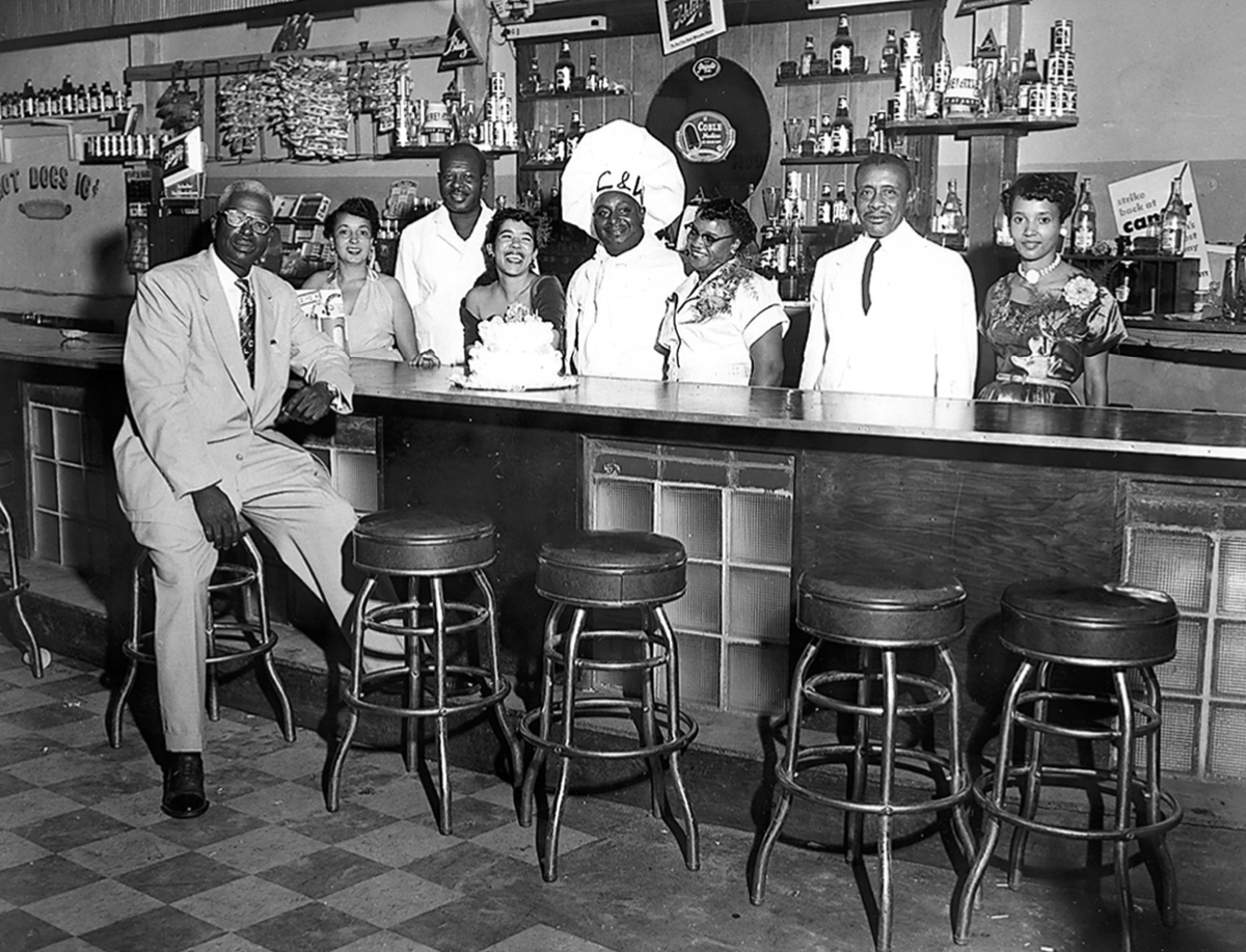 A photo of Charlie Fitzgerald and his staff, Fitzgerald is sitting on the far left.