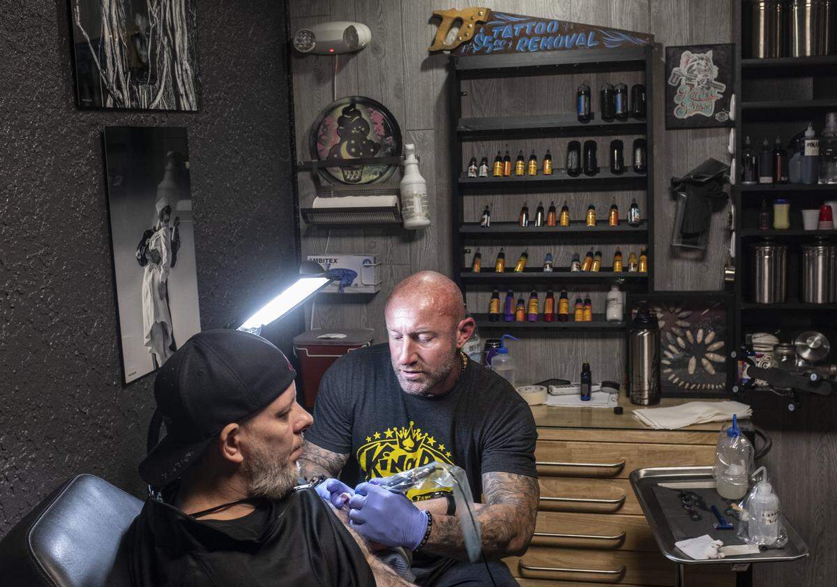 Chris Lachnicht works on a tattoo for Steve Atkinson at Top Notch Tatoos on Wednesday afternoon.More “non-essential” small businesses closed Wednesday in Myrtle Beach after S.C. Governor McMaster’s issued his latest mandate shuttering entertainment venues and massage and tattoo parlors and other places where customers come into close contact with workers. April 1, 2020.