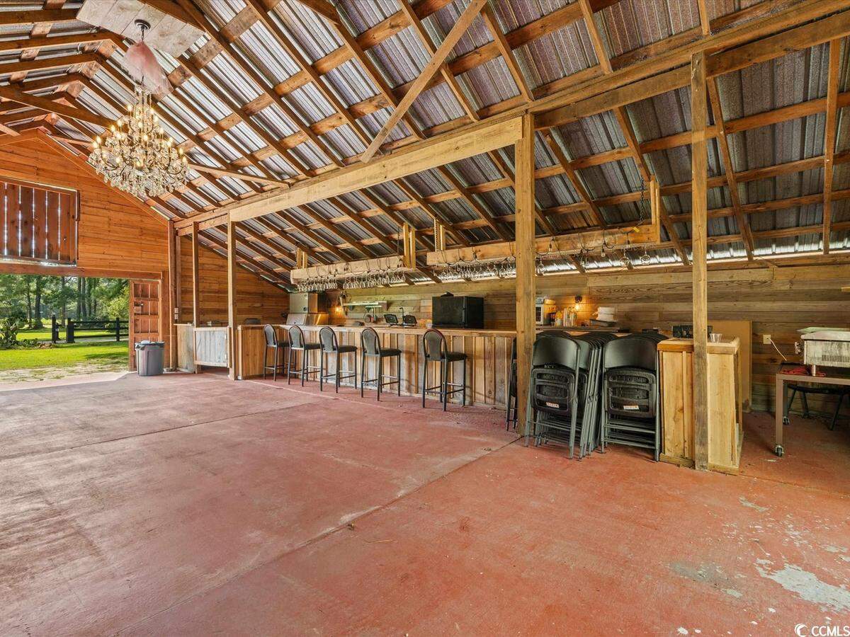 The event space within the barn. You can see the space available for a bar, the chandelier and where the dance floor could be located.