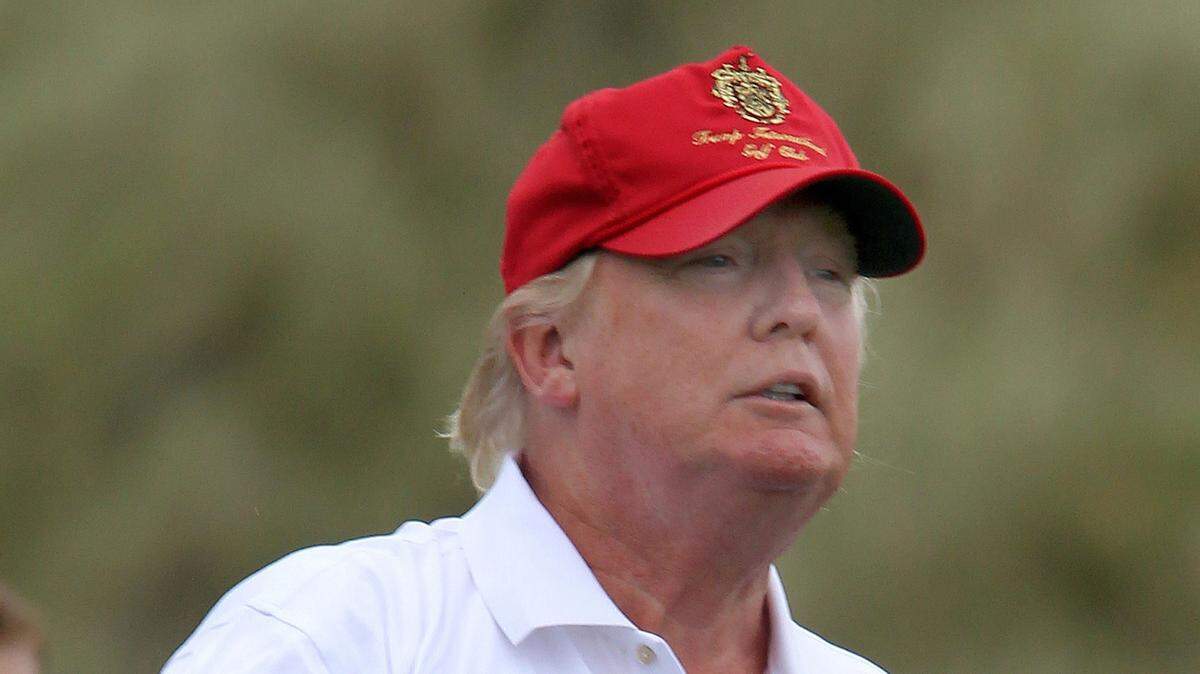President Donald Trump plays golf at one of his resorts in this file image. Trump's net worth slipped to $2.8 billion, a decline of $100 million over the past year. (Andrew Milligan/PA Wire/Zuma Press/TNS) 