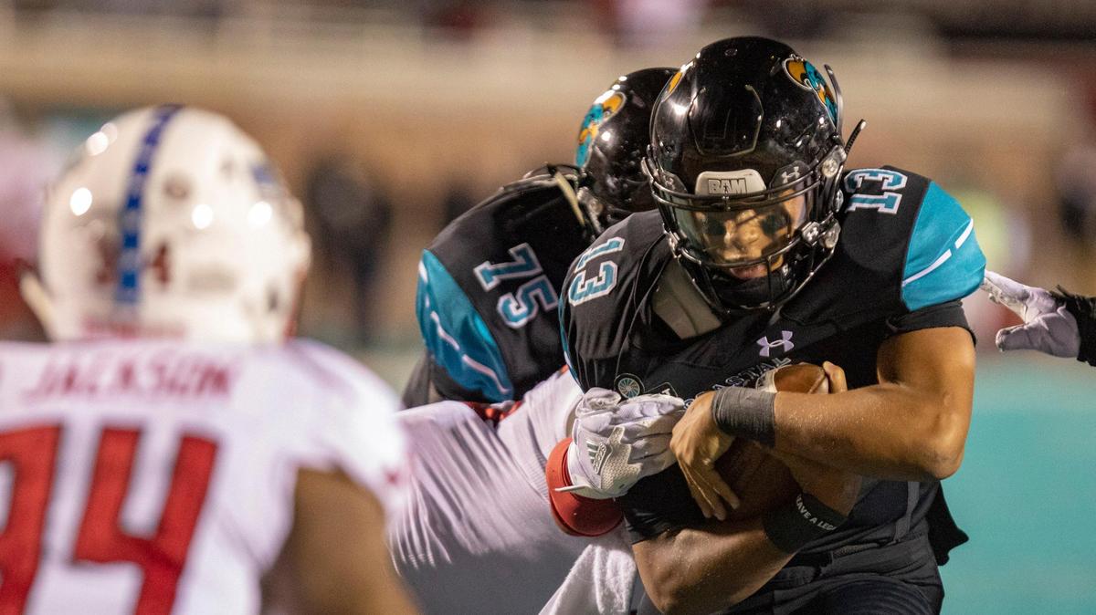 Coastal Carolina freshman quarterback Fred Payton runs the ball against the Arkansas State Red Wolves Saturday night at Brooks Stadium in Conway.