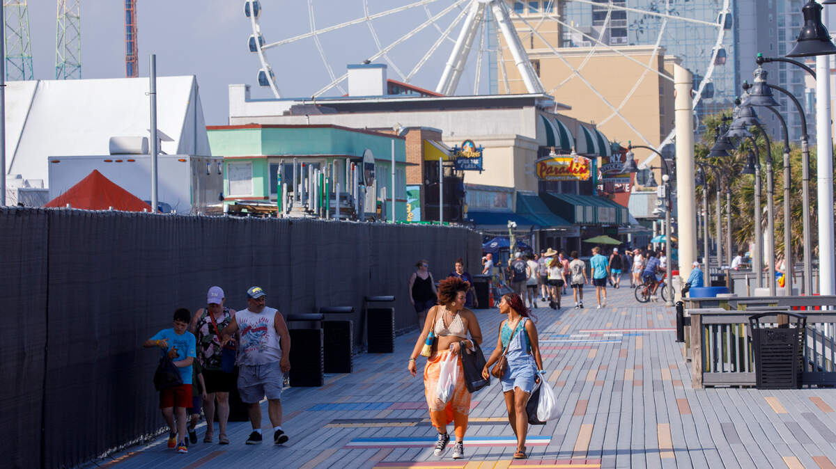 People walking on the Myrtle Beach Boardwalk and Promenade in June 2024. 
