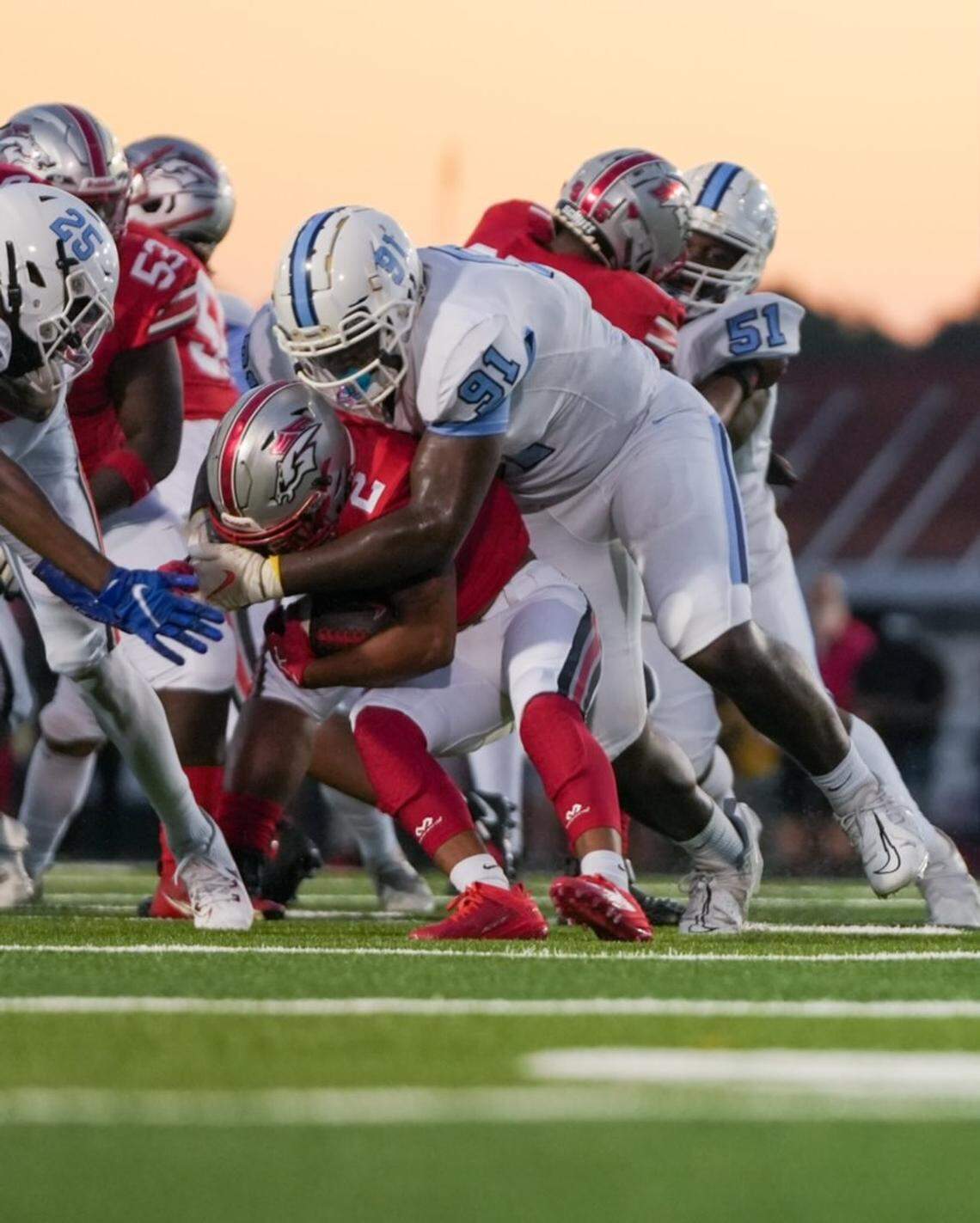 South Florence High School’s Amare Adams, number 91, makes a tackle