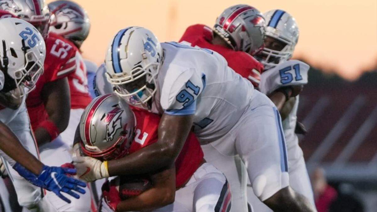 South Florence High School’s Amare Adams, number 91, makes a tackle