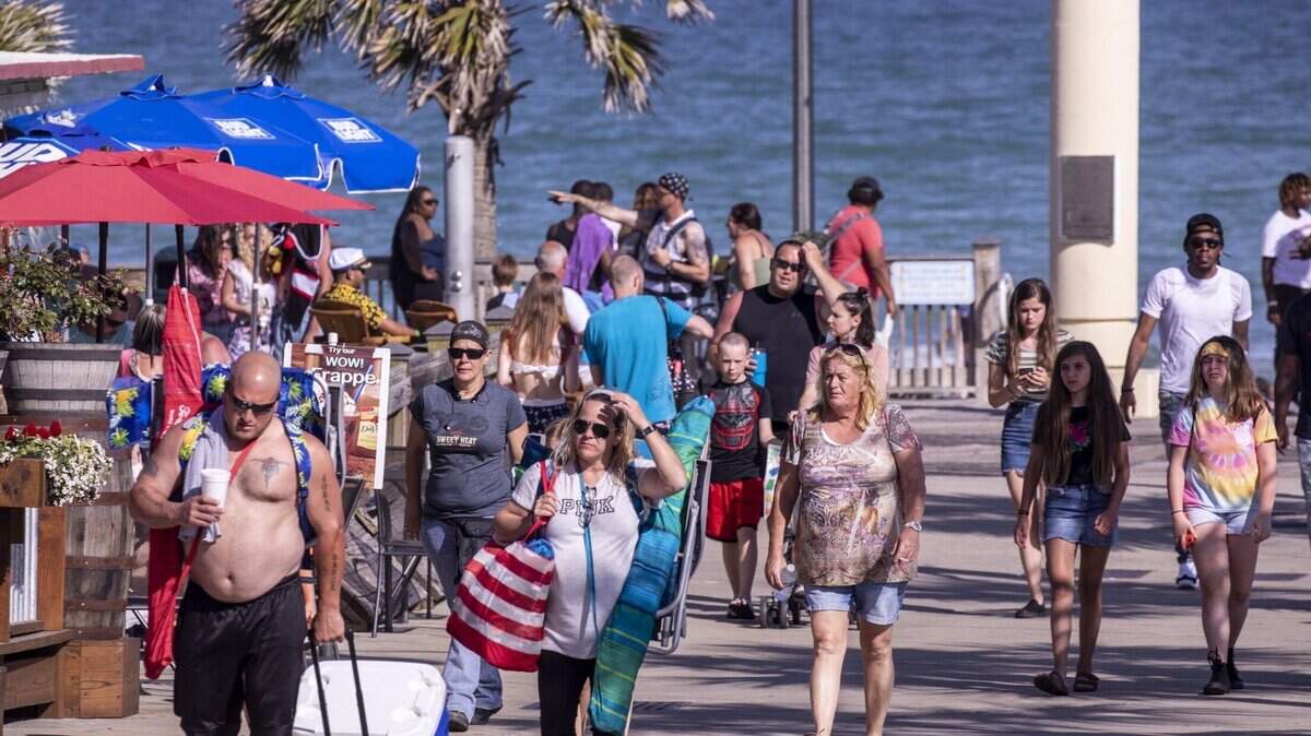 Tourists walk among the shops in Myrtle Beach’s popular Ocean Boulevard tourism area. Tourists and locals have expressed mixed feelings following the third shooting in the area in recent months, which happened on Friday. TSN 2021 File.