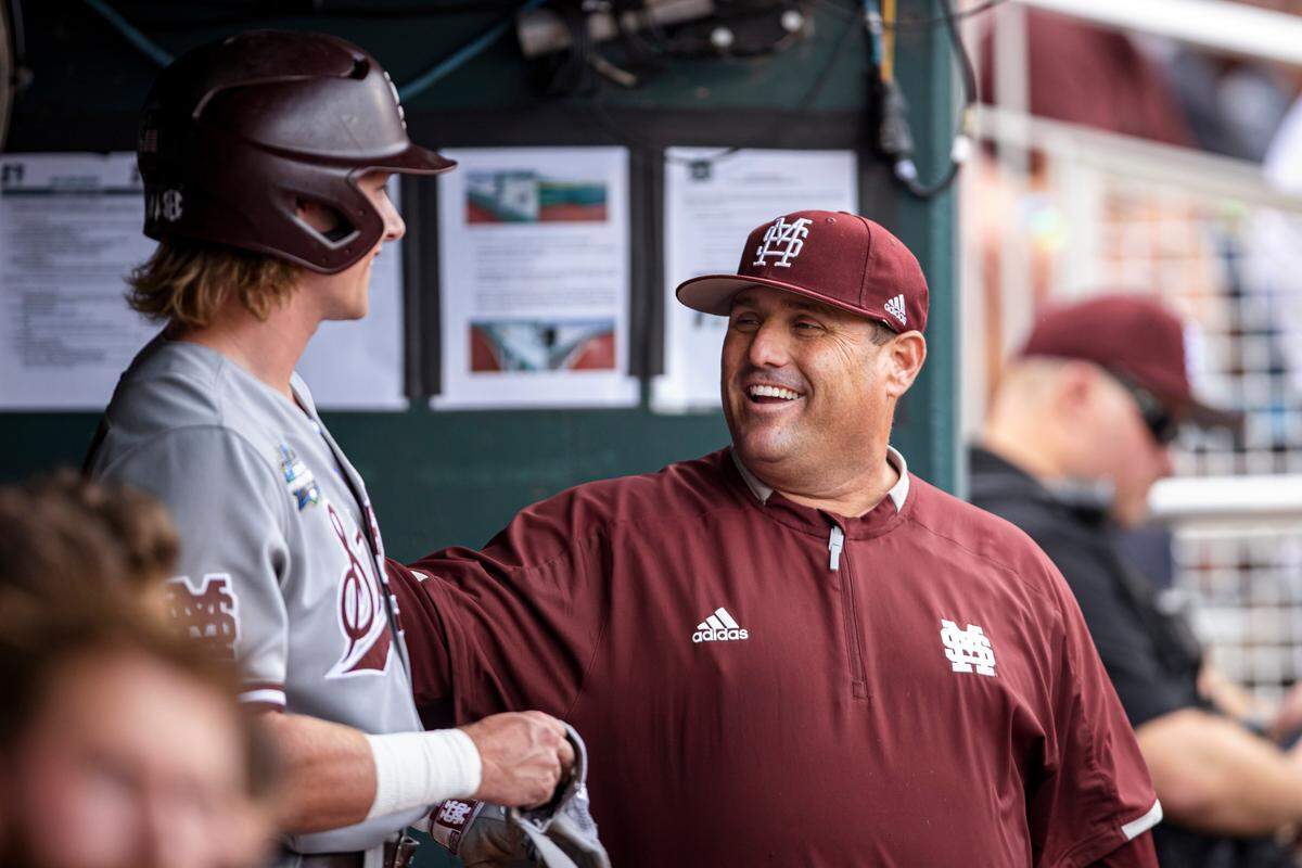 Mississippi State outfielder Rowdey Jordan (left) and head coach Chris Lemonis before Game 1 of the 2021 College World Series national championship series between the Bulldogs and Vanderbilt.