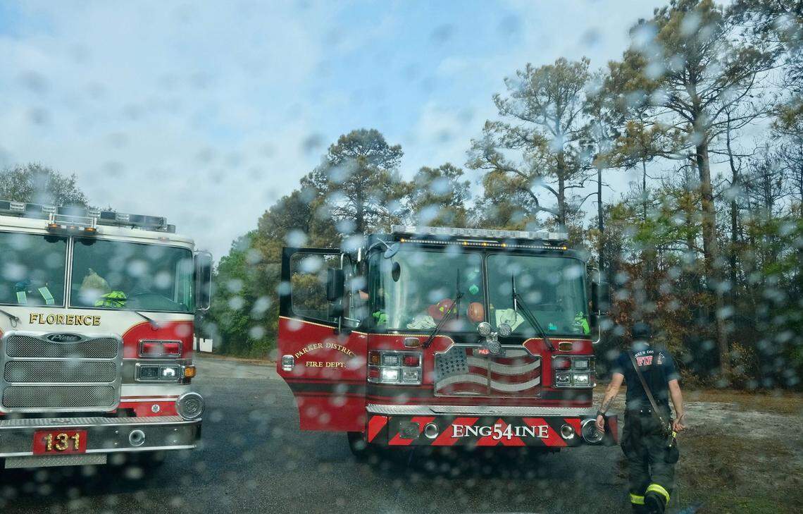 Some much-needed rain begins to fall on Florence and Greenville, SC area fire engines and crews in the Reserve at Walkers Woods on Wednesday as the wildfires enter their fifth day of burning in the Myrtle Beach area. The blaze impacts more than 2,000 acres of land with strong winds and occasional rain possible March 5, 2025.