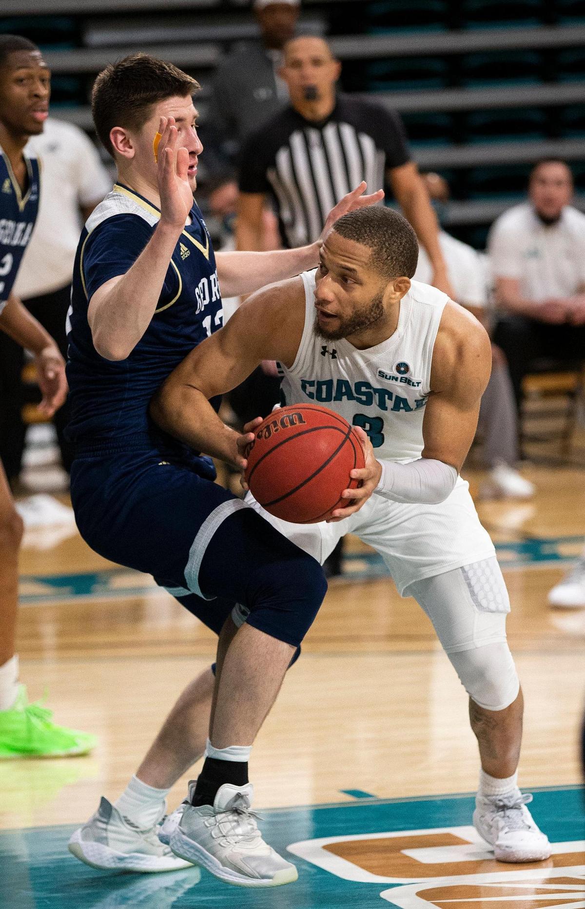 Coastal Carolina guard DeVante Jones (3) looks to shoot in the lane against a Georgia Southern defender on Sunday at the HTC Center in Conway.