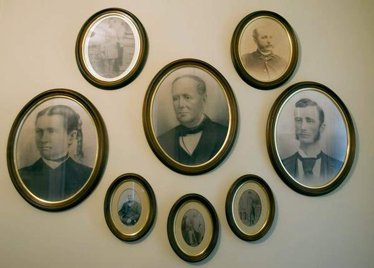 “A wall of unhappy people,” Susanna Buck Register describes photographs of her ancestors at Upper Mill Plantation outside of Conway on Friday, April 8, 2011. The Bucks established the plantation in 1828 after Capt. Henry Buck moved to the area from the north. The plantation is the site of the first steam operated lumber mill in America. Susanna Buck Register said her ancestors actually paid the slaves on the plantations they owned. The Bucks also held Middle Mill, which is now at Bucksville Landing, and Lower Mill, which is in Bucksport. The plantations produced lumber for ship building, cypress shingles, cotton, rice, sweet potatoes and corn. According to the Horry County Historical Society, there were 133 slaves on the plantation in 1850. Ten years later, there were 312 slaves. Susanna Buck Register said slaves used to lay on the front porch, out of sight from the Buck family, to listen for updates about the Civil War. The Civil War began on April 12, 1861, and ended April 9, 1865. In those four years, an estimated 620,000 soldiers died. Photo by Janet Blackmon Morgan / jblackmon@thesunnews.com