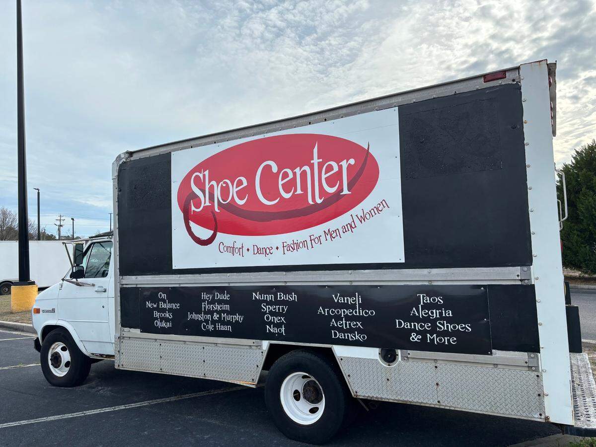 The Shoe Center truck parked in the parking lot of North Strand Plaza Shopping Center, where the store is located.