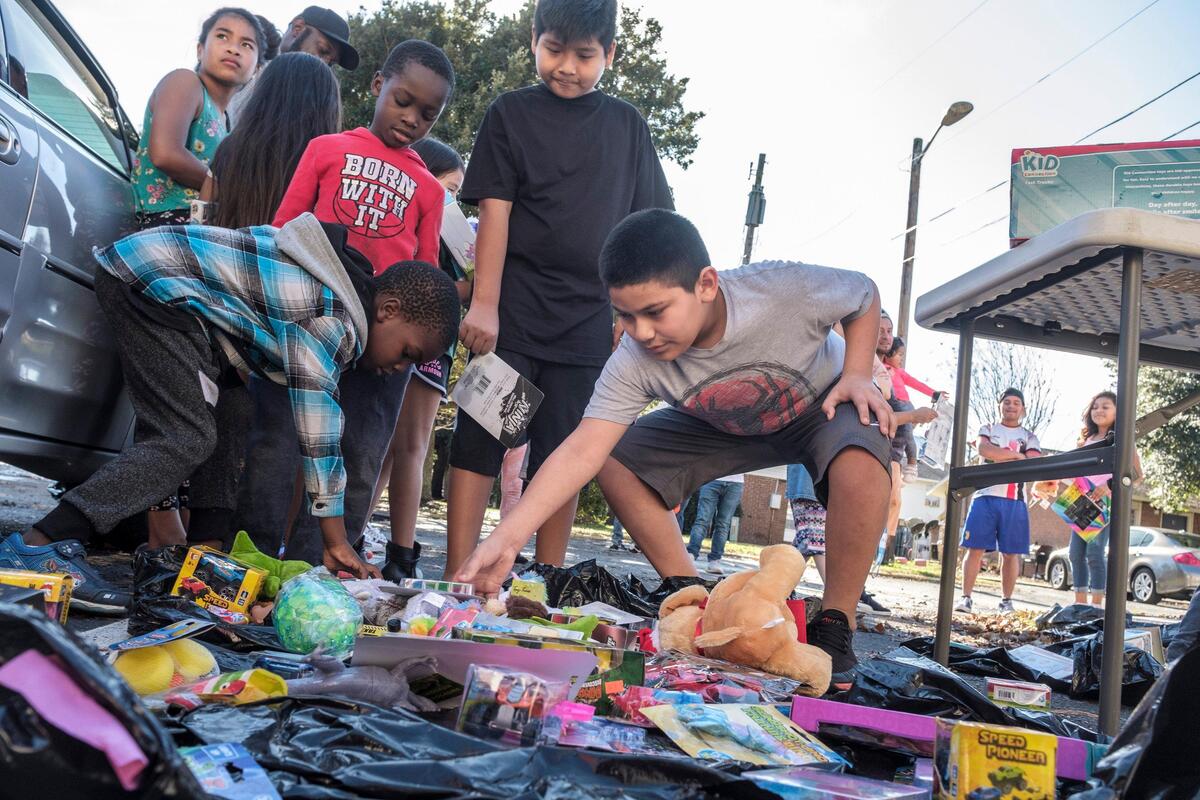 Children in the Ocean Breeze apartments pick out gifts delivered by Myrtle Beach High School coaches Jeremy Howard and Docshee Moore, and urban retailer DTLR employees on Christmas Eve.