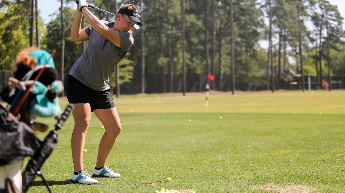 Coastal Carolina golfer Malene Krolboll Hansen takes a swing on the driving range at the Hackler Course at Coastal Carolina University.