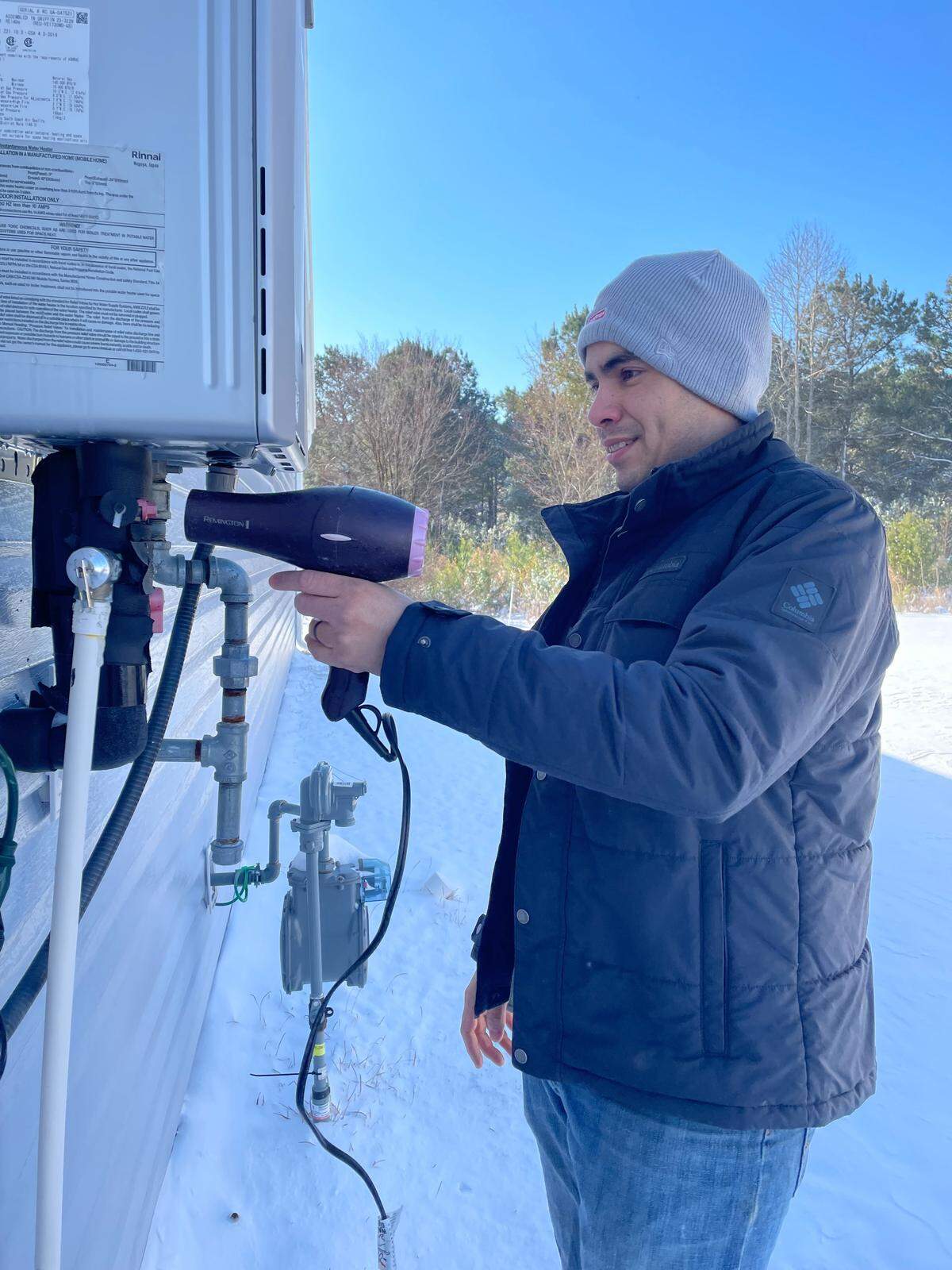 Jose Dugarte on Sunday, Feb. 1, 2026, uses a hair dryer to unthaw pipes at his Conway area home that were frozen after temperatures reached single digit temperatures because of wind chills along the Grand Strand.