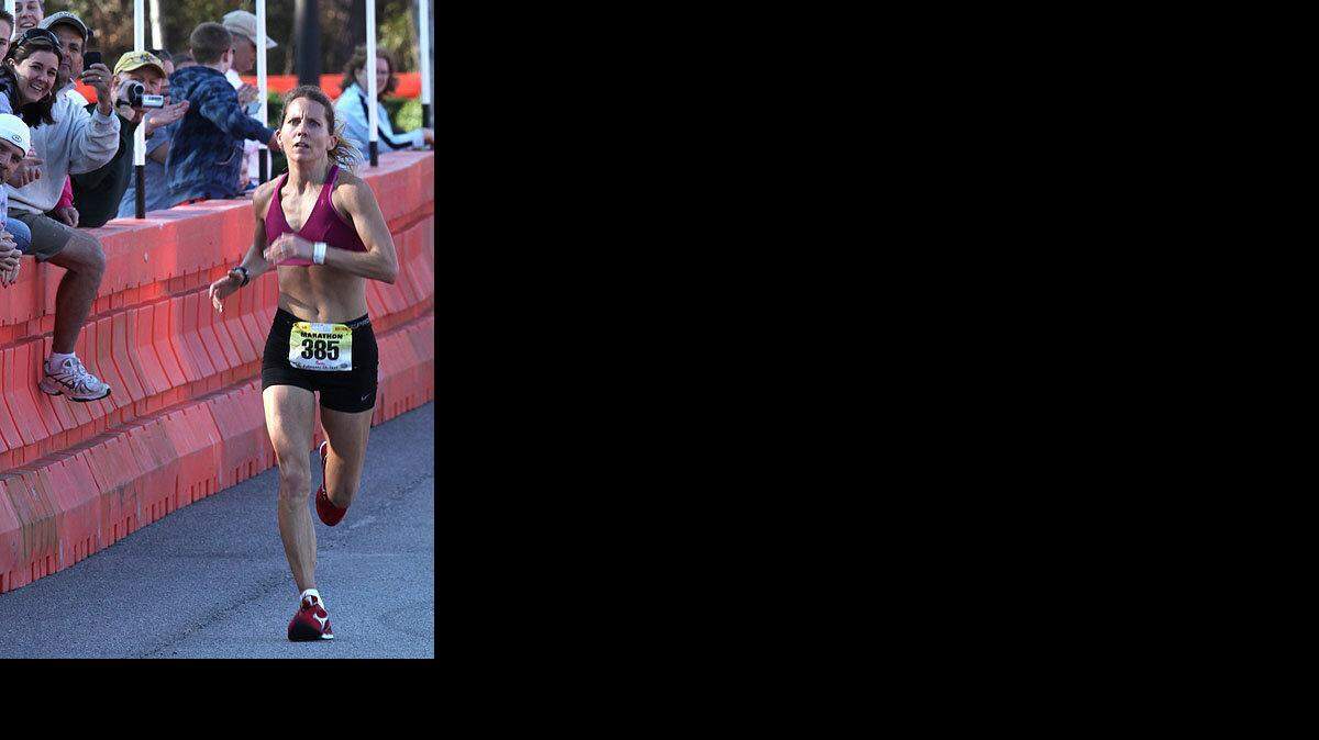02-19-11/Saturday-----Marathon overall winner Kathleen Castles of New Providence, N.J., runs to the finish line during the 2011 Bi-Lo Myrtle Beach Marathon Saturday morning in Myrtle Beach. She is the first woman to win the overall race.  Photo By Randall Hillrhill@thesunnews.com