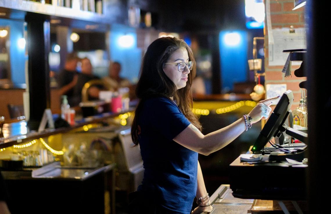 Ashley Schaef, works as a bartender at Sugru’s Pub in North Myrtle Beach, S.C. Sept. 30, 2021.