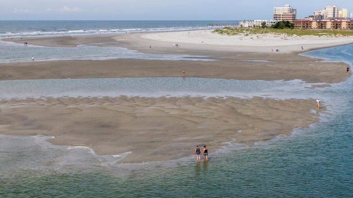 Beach goers enjoy the sand bars and tidal pools in Cherry Grove during low tide. Both Cherry Grove and surrounding North Myrtle Beach were nominated for the best beach in South Carolina.
