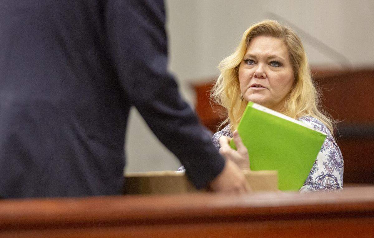 Tammy Moorer speaks to attorney Greg McCollum Thursday morning at the Horry County courthouse. Moorer is on trial for kidnapping and conspiracy related to the Heather Elvis disappearance.