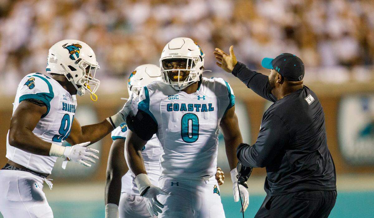 Coastal Carolina defensive end Josaiah Stewart (0) receives congratulations after a sack against Kansas at Brooks Stadium on Aug. 11, 2021. The true freshman set a school record with 3.5 sacks in just his second college game.