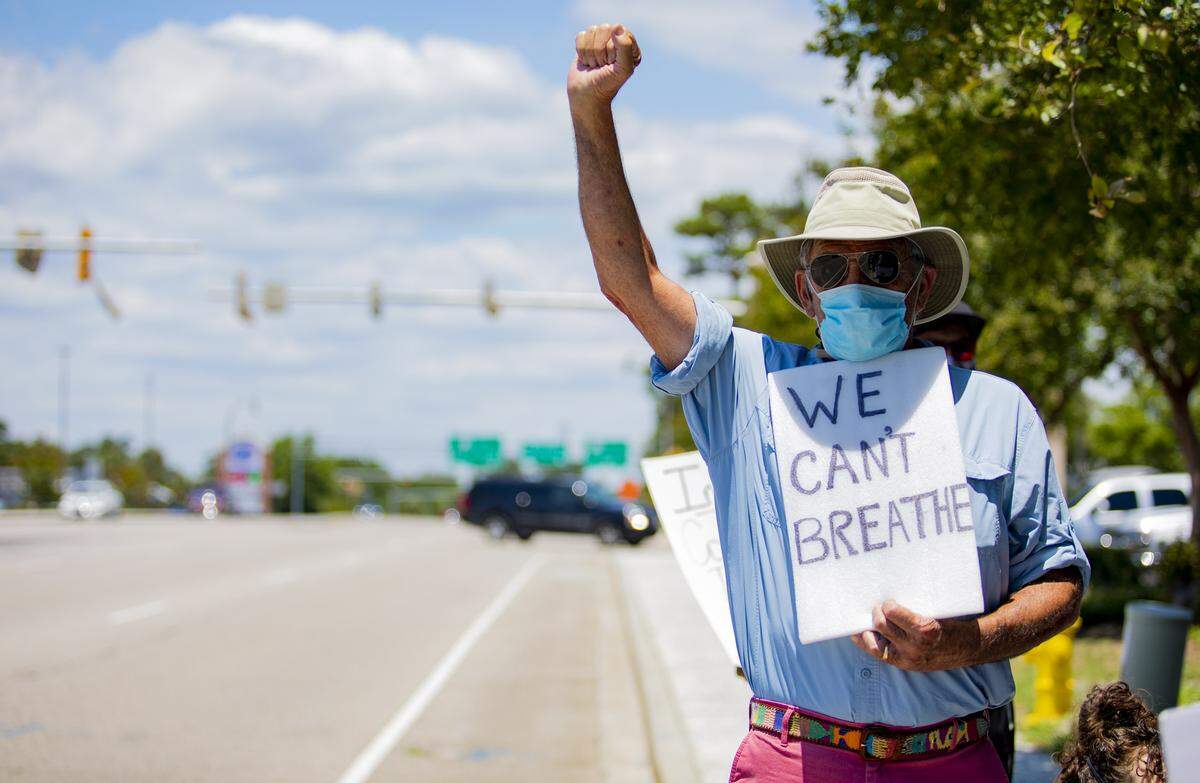 A protester holds his fist up as crowds gather along Main Street in North Myrtle Beach Tuesday afternoon to protest police brutality and the murder of George Floyd, who was killed by Minneapolis, Minn. police officer Derek Chauvin on May 25.