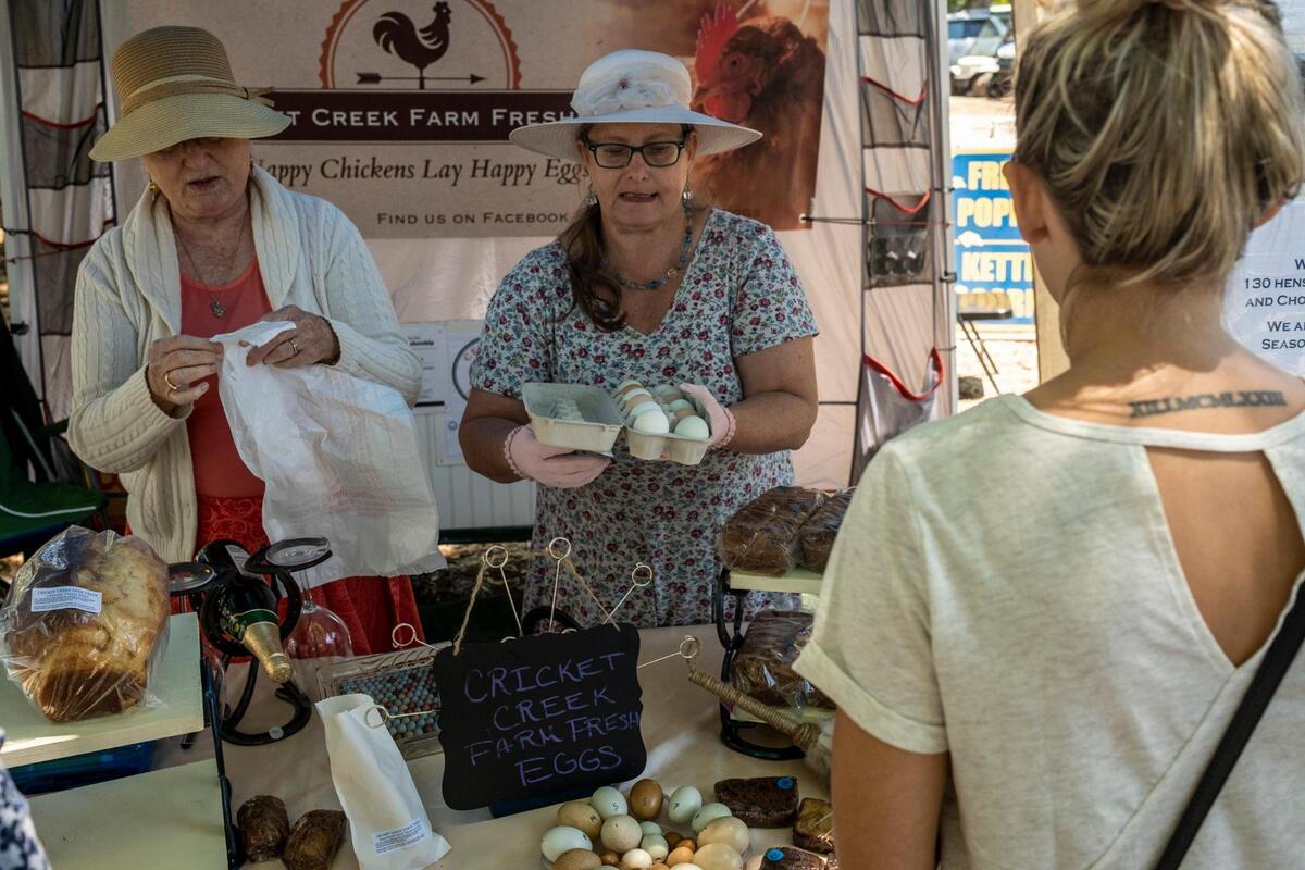 Brenda Hicks (right) and Joan Wood with Cricket Creek Farms sell fresh chicken and turkey eggs and baked goods at the Surfside Beach Farmers Market, The Surfside Market is part of the Waccamaw Market Cooperative, is held every Tuesday from 10am-3pm from April through the October with farmers, artisans, bakers and chefs selling locally produced goods. The cooperative hosts seven markets around the Grand Strand. May 10, 2022.